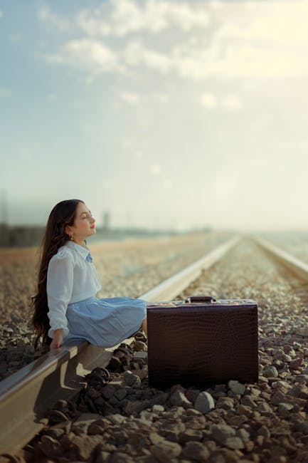 A person sitting on tracks waiting for a train